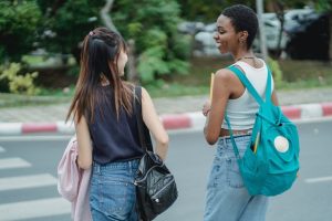 two pedestrians crossing the street