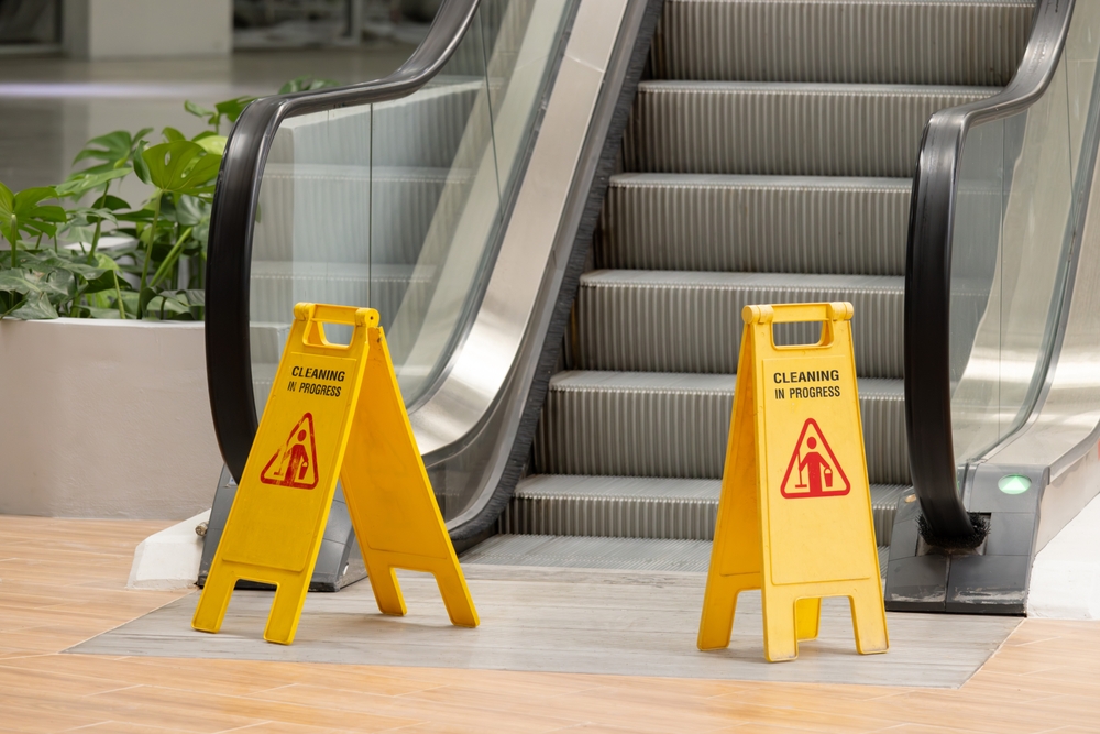 Standees block the foot of an escalator