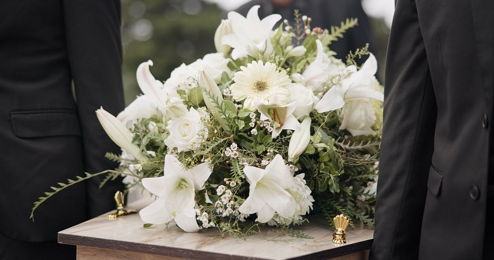 Image of flowers atop a casket