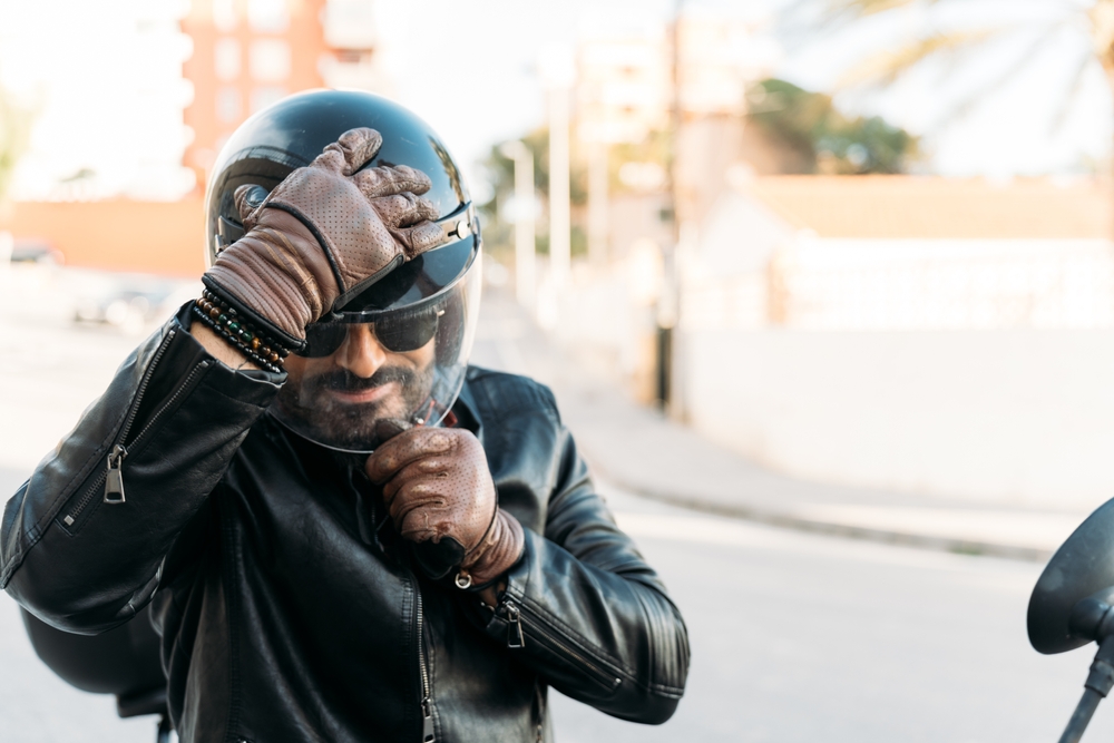 Motorcycle rider adjusting helmet before riding